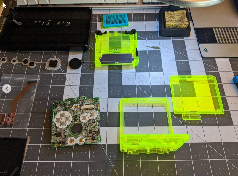 A disassembled GBA SP that is being modded.